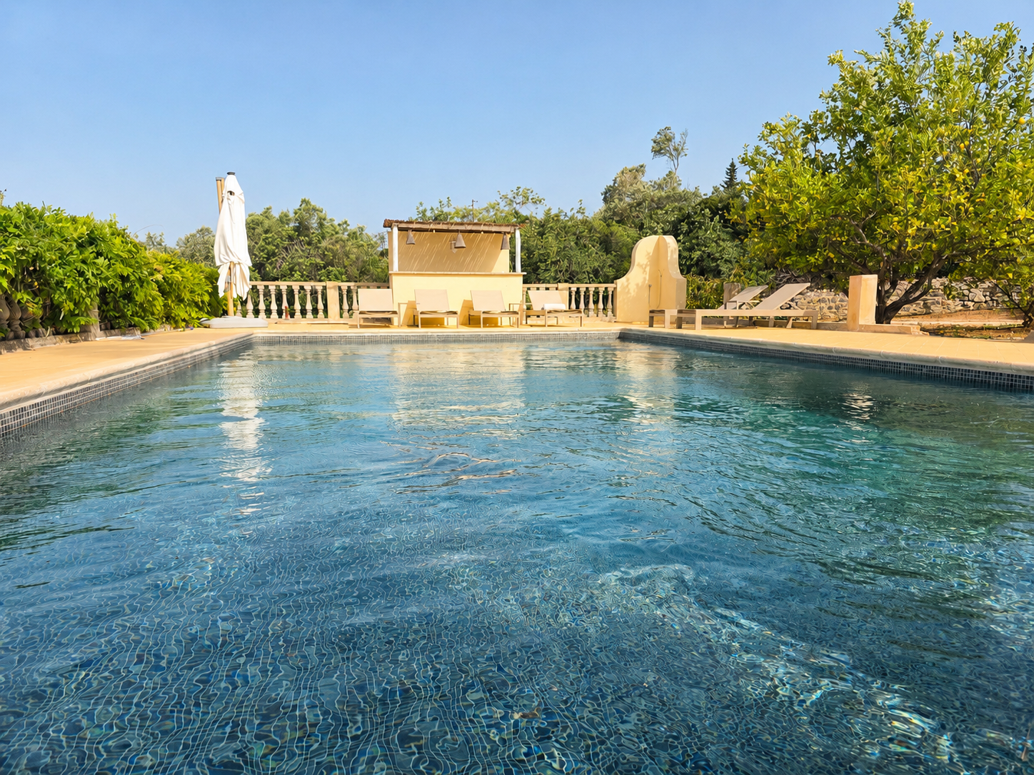 Heated pool at Casa Amani surrounded by lush Mediterranean garden
